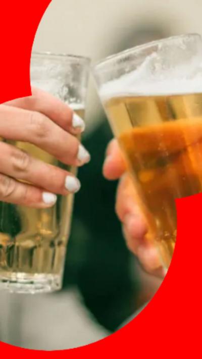 Close up of two glasses of beer as they cheers.