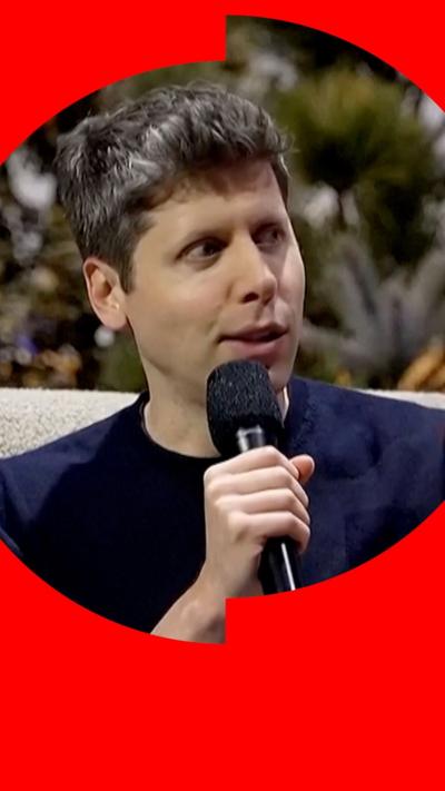 Sam Altman holding a microphone