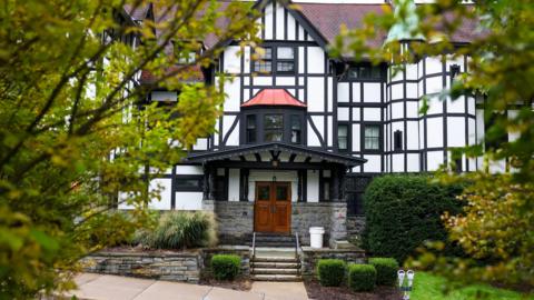 Exterior of Cornell University’s Chi Phi fraternity house showing a white building with mock tudor style black details, in Ithaca, New York, US, September 29, 2026.