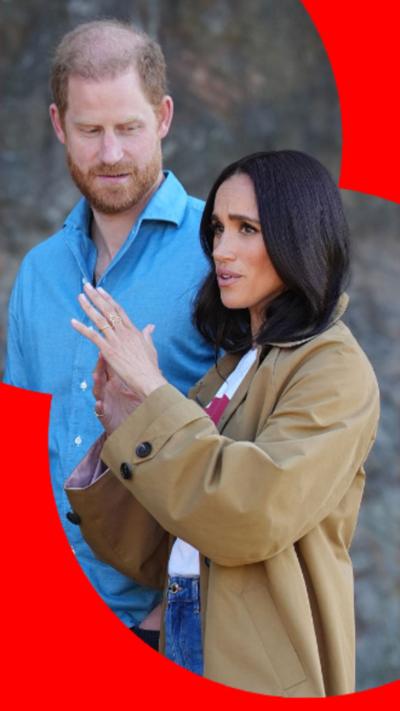 Prince Harry and Meghan Markle stood side by side, both looking away from the camera.