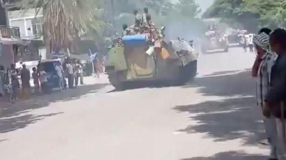 Armed men on armoured vehicles drive through Alamata, Ethiopia