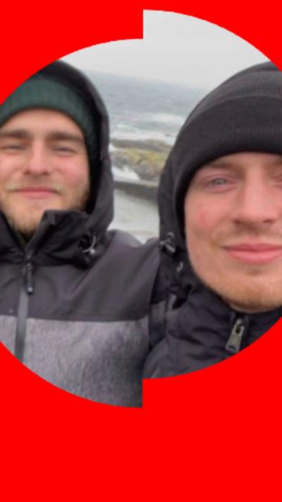Two men taking a selfie outdoors