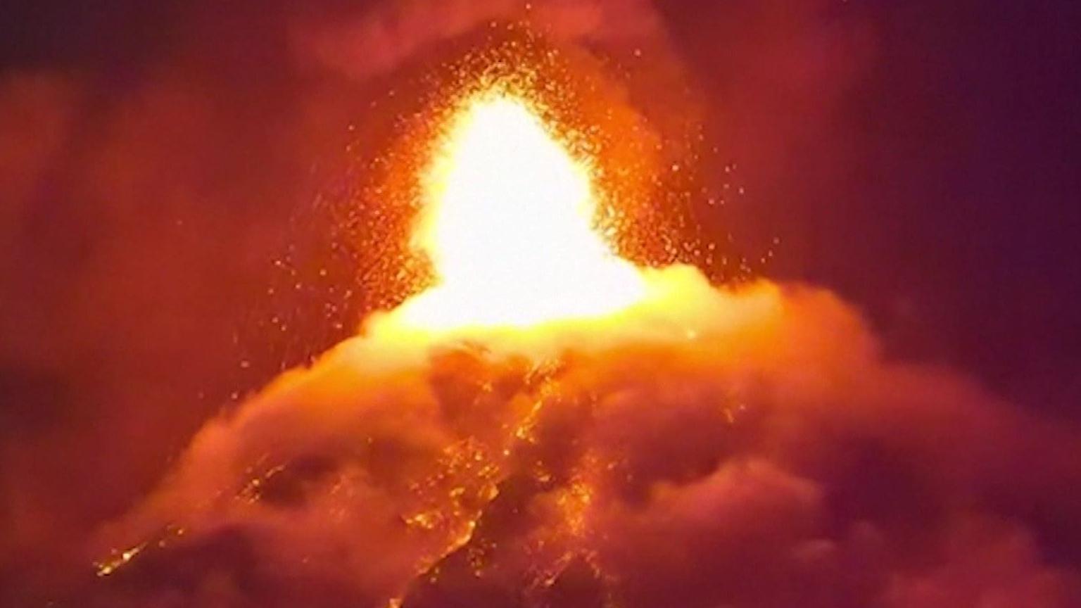 A screengrab taken from CCTV footage at nighttime shows lava bursting from the crater of the Fuego volcano