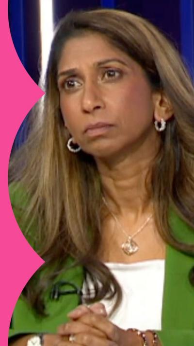 A woman with long, light brown hair looks at someone off-camera.