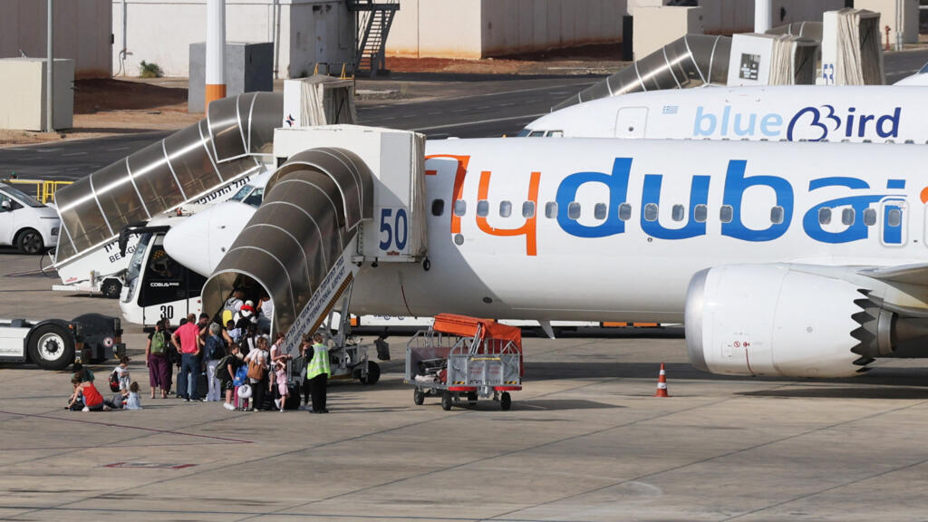 Travelers board a FlyDubai aircraft at Ben Gurion International Airport after a separate flight was diverted to Saudi Arabia following an emergency signal, in Israel on September 30, 2026.