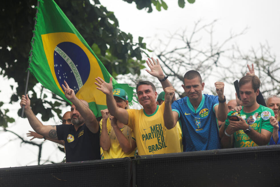 Flavio Bolsonaro waves to supporters as he leads a motorcade in Rio de Janeiro on October 3, 2026.