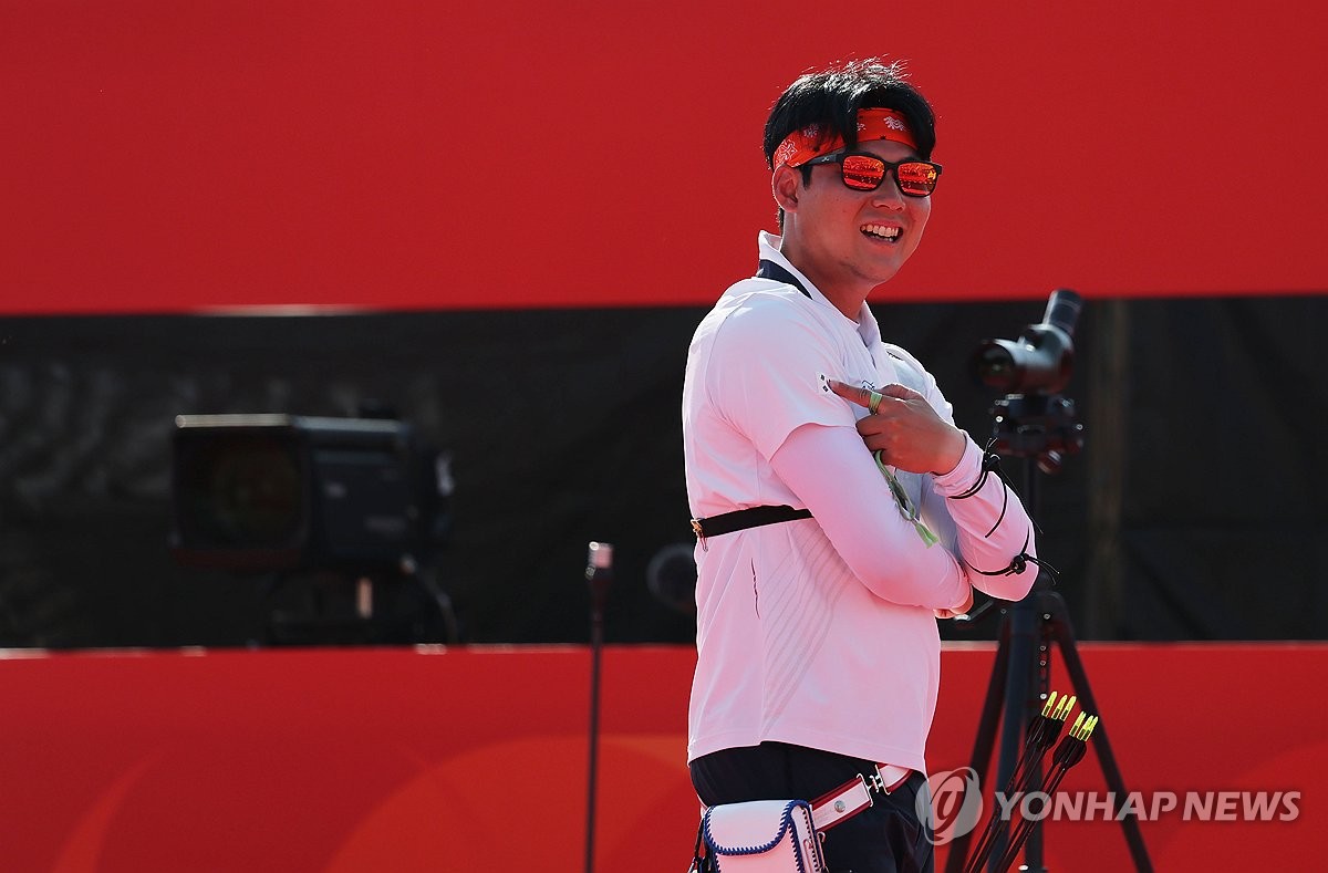 Lee Woo-seok of South Korea points to the national flag, Taegeukgi, on his uniform after winning gold in the men's individual event in recurve archery at the Aichi-Nagoya Asian Games at Okazaki Chuo Sogo Park Multipurpose Square in Okazaki, Japan, on Oct. 3, 2026. (Yonhap)