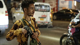 A member of the security forces of the internationally-recognised Yemeni government mans a checkpoint on a street in Taiz.
