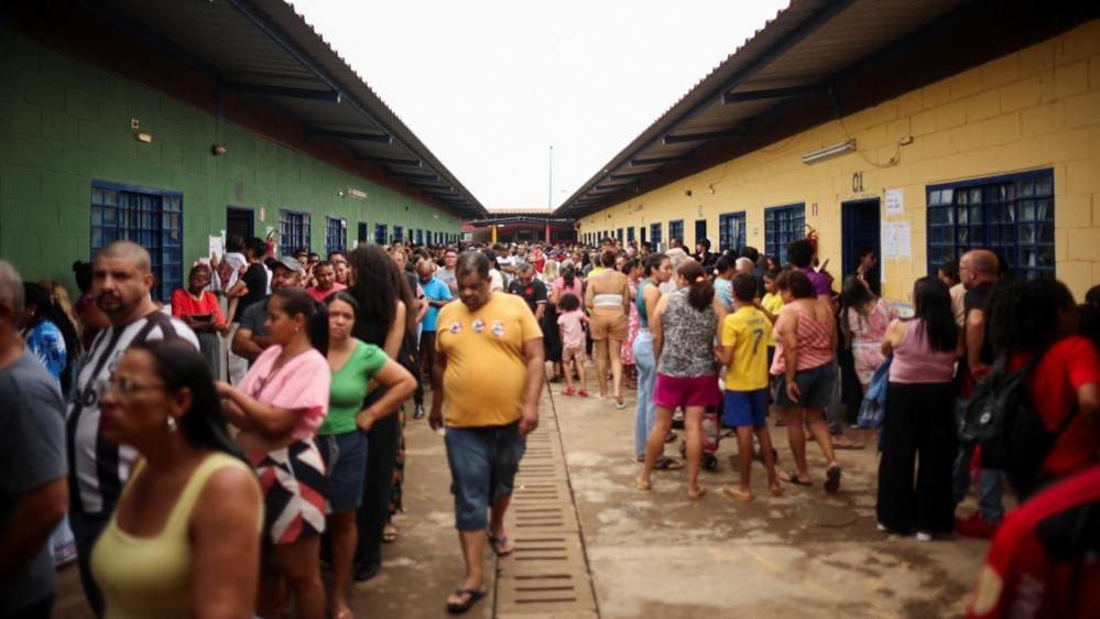 People gather as they vote during Brazilian general elections at a polling station located in a school in Sol Nascente in Brasilia