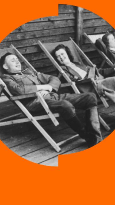 A black and white picture of a man and woman in uniform relaxing in deckchairs