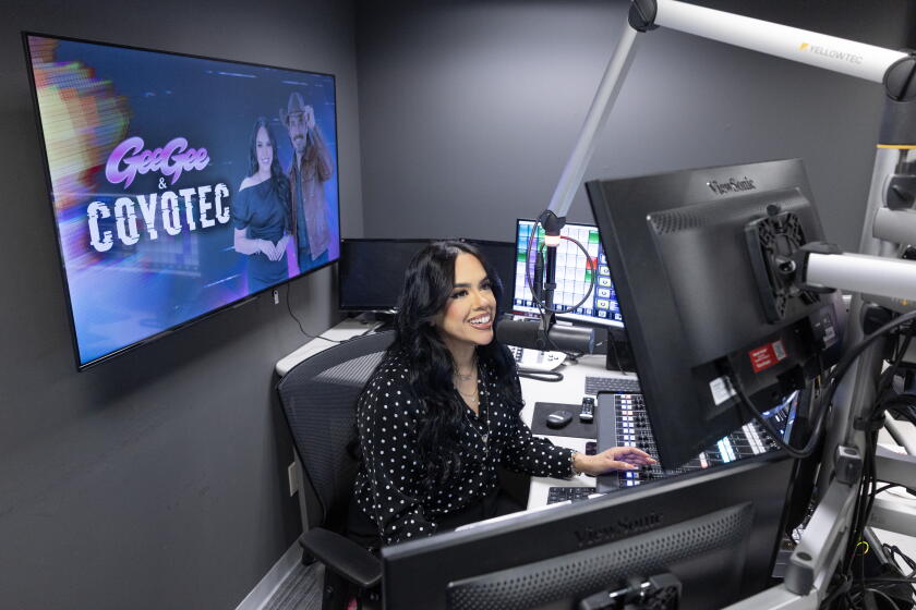 BURBANK, CA - SEPTEMBER 29, 2026: Geraldine "GeeGee" Guzman hosts a radio show on Jose 97.5 FM with an AI DJ - Coyotec. Photographed at Jose 97.5 FM in Burbank, CA on Tuesday, Sept. 29, 2026. (Myung J. Chun / Los Angeles Times)