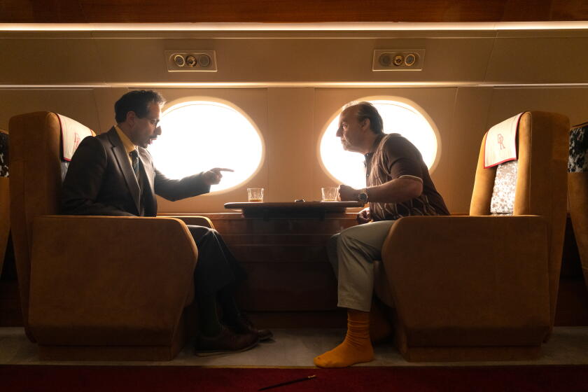 (L-r) RIZ AHMED as Ganesh and TOM CRUISE as Rockwell in Warner Bros. Pictures' "DIGGER," a Warner Bros. Pictures release.