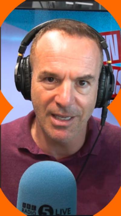 Martin Lewis has short dark hair and is wearing headphones and a purple top.