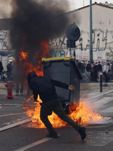 A protester throws a garbage bin into a fire outside the Lycee Deodat-de-Severac high school as part of nationwide protests by high school students to demand the hiring of substitute teachers, increased resources and better learning conditions, in Toulouse as more than 400 schools remain closed following days of student protests that have escalated into violence in some places, France, October 2, 2026.