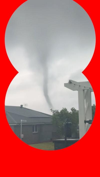 A tornado passes through a residential area.