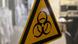 A yellow warning sign signifying biohazards A yellow warning sign signifying biohazards