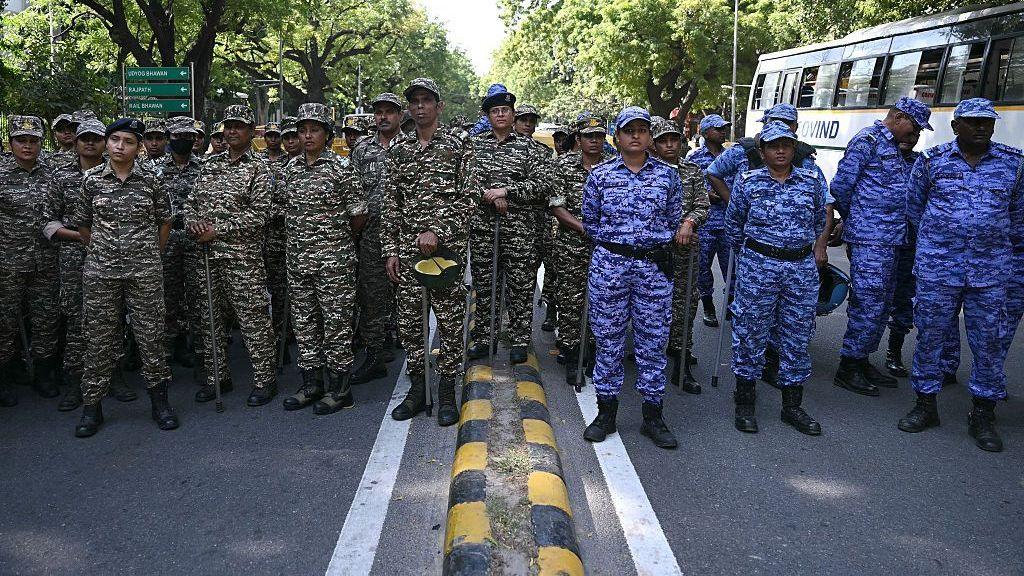 Security officials belonging to the Central Reserve Police Force (CRPF) and Rapid Action Force (RAF) personnel assemble near the Election Commission of India office in New Delhi ahead of the protest march on 6 October.