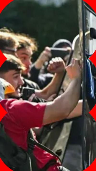 Students bang against shields held by riot police.