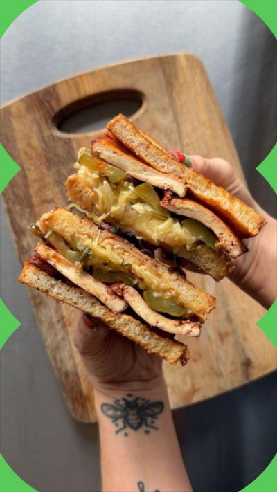 A halved sandwich above a wooden chopping board