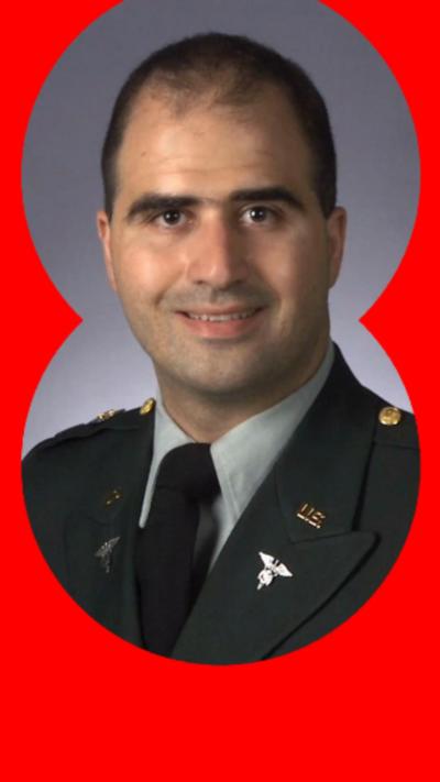 A man with short dark hair and dressed in a US Army suit.