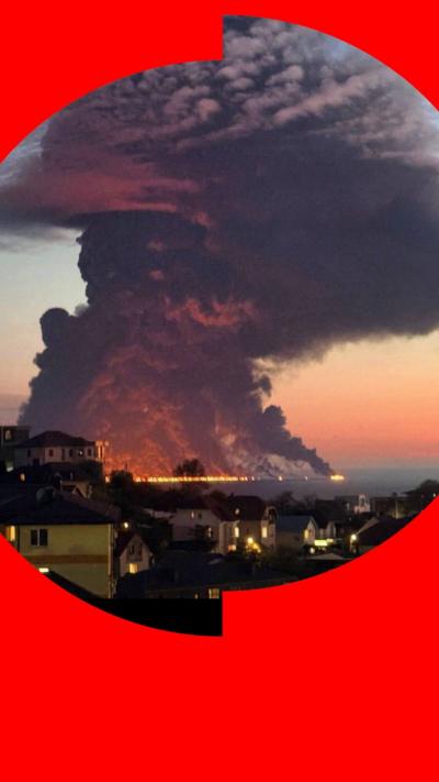 A huge plume of smoke rises from a burning oil tanker and burning oil on the sea at the Russia resort of Sochi.