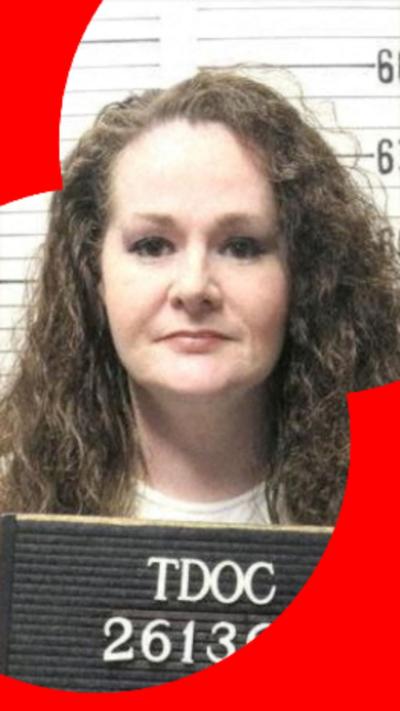 A mug shot of Christa Pike who has long, dark, curly hair.