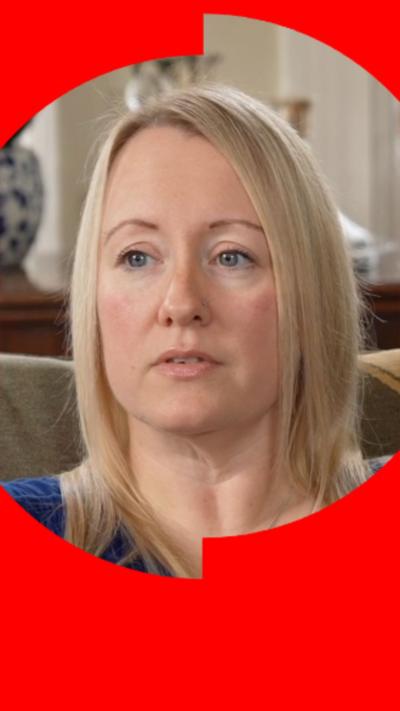 A woman with shoulder-length blonde hair looks at someone off-camera