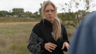 Olena standing in the countryside