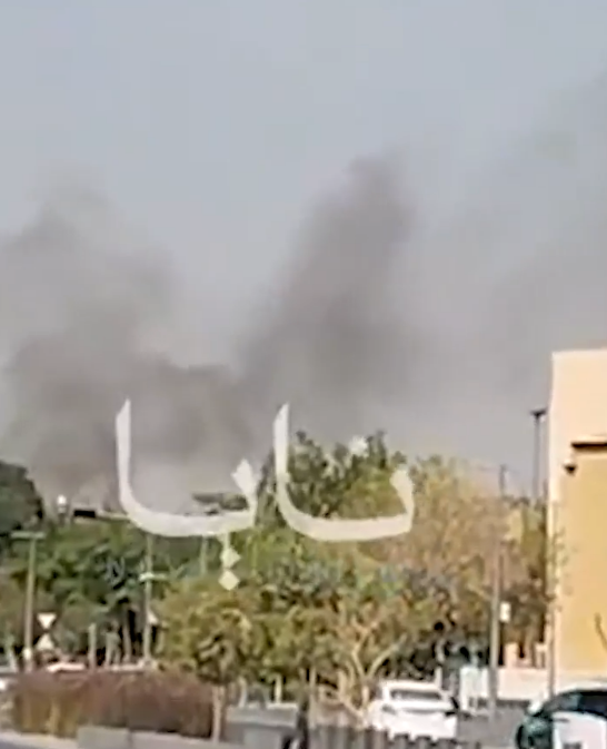 Thick smoke rising behind trees and buildings in Riyadh.