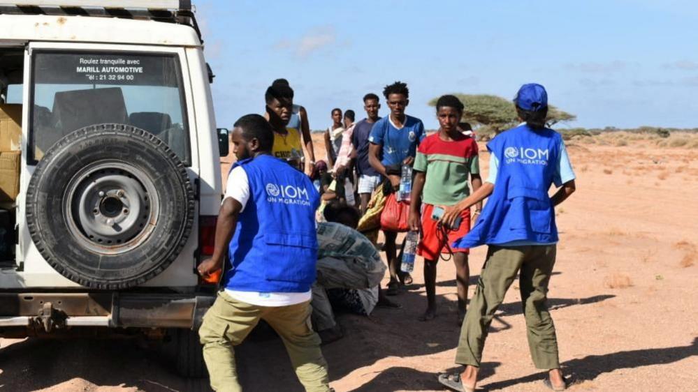 Rescue workers receive migrants near Guhere, north of the port town of Obock, Djibouti on October 10