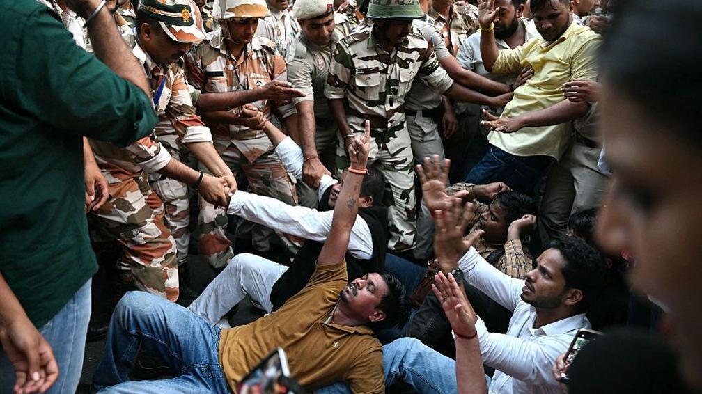 India's opposition Congress party supporters scuffle with security personnel during a protest