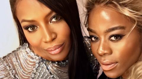 A selfie of Antonia with model Naomi Campbell. The pair and close together and smiling at the camera. Naomi's hair is sleek, dark and long.