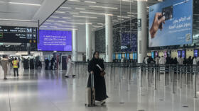A traveller rolls her suitcase through the departure terminal of King Khalid International Airport in Riyadh on April 2, 2026. 