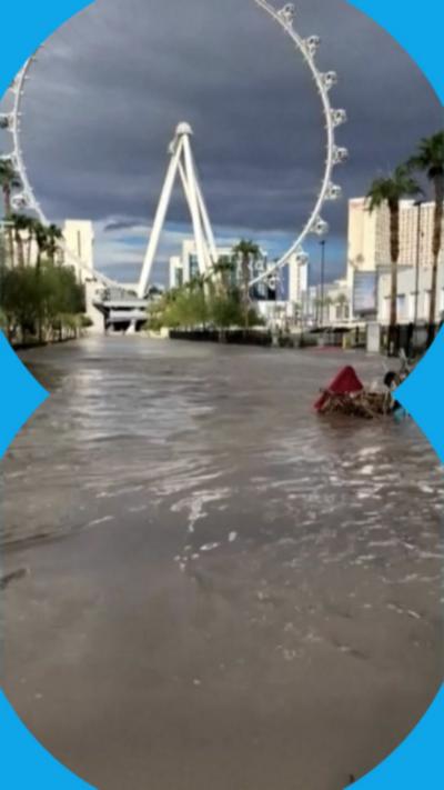 Footage shows a Las Vegas street near the strip covered in knee-high water.