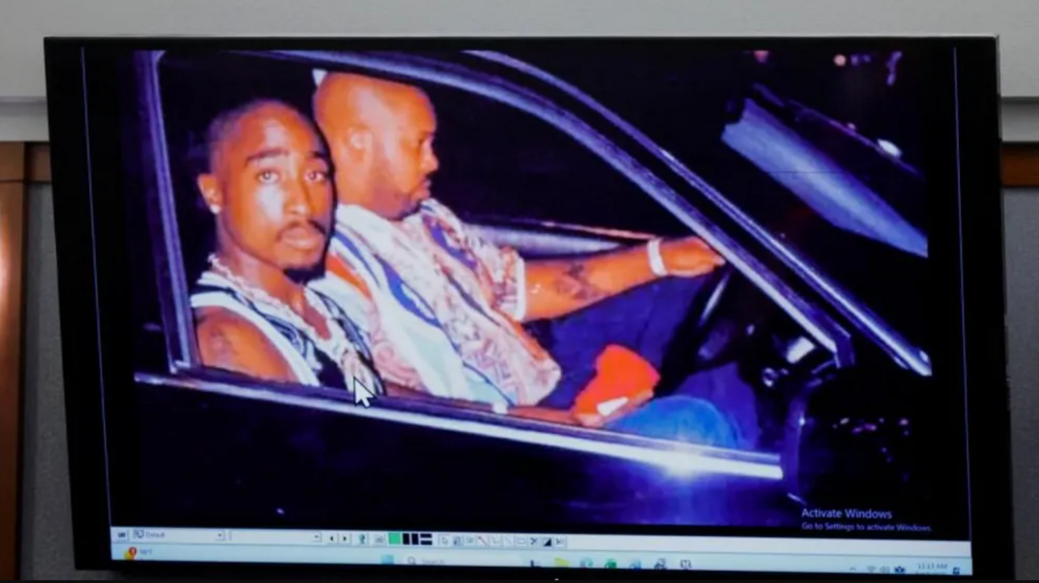 A 1996 photo of rapper Tupac Shakur (L) and Marion "Suge" Knight displayed during the murder trial
