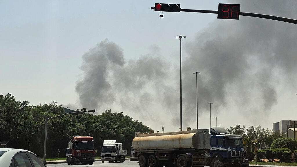 Vehicles travel along a road in Riyadh as black smoke billows from a fire at a nearby oil facility in this file photo from October 3, 2026.