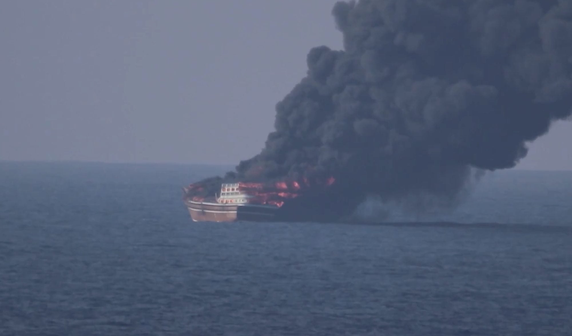 Dhow engulfed in flames in the Gulf of Oman, sending a massive plume of thick black smoke into the sky following a U.S. military strike on October 6, 2026.