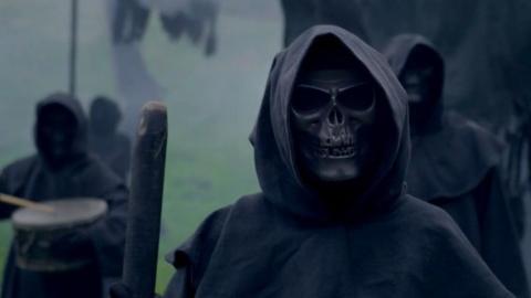 Death marchers in skull masks and black robes