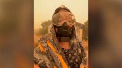 Woman wears an eye and face gas mask