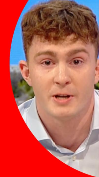 Archie Goodburn looks emotionally at the camera wearing a white shirt.