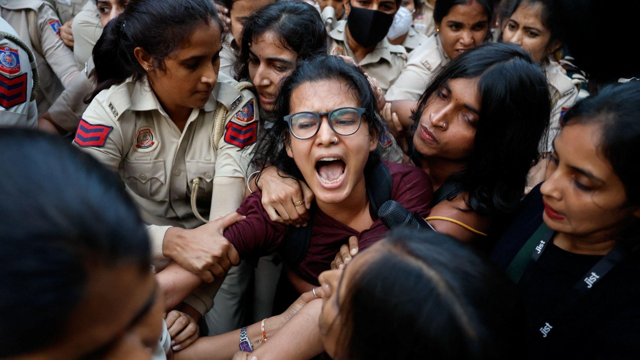 Police officers detain All India Students' Association (AISA) President Neha Bora during a flag rally seeking the resignation of India's Chief Election Commissioner Gyanesh Kumar, in New Delhi, India, October 16, 2026. 