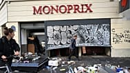 A man walks past a looted store the day after a demonstration against rising living costs and in solidarity with students’ grievances, in Paris, Sunday, Oct. 18, 2026.