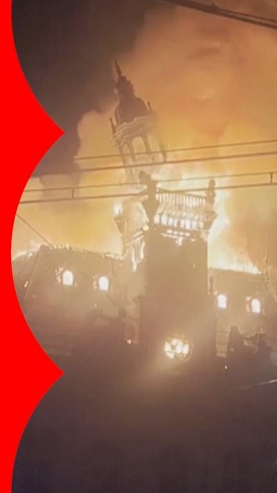 The Limoges town hall steeple collapses amid a giant inferno.