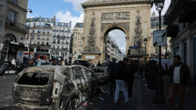 People inspect a destroyed vehicle, the day after clashes during a national day of demonstrations against the cost of living and rising fuel prices, in Paris, France, October 18, 2026