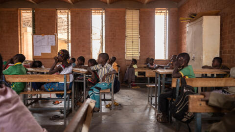 Des écoliers suivent un cours dans une salle de classe de l'école «Village-Opera», à Laongo, au Burkina Faso, le 16 mars 2022.