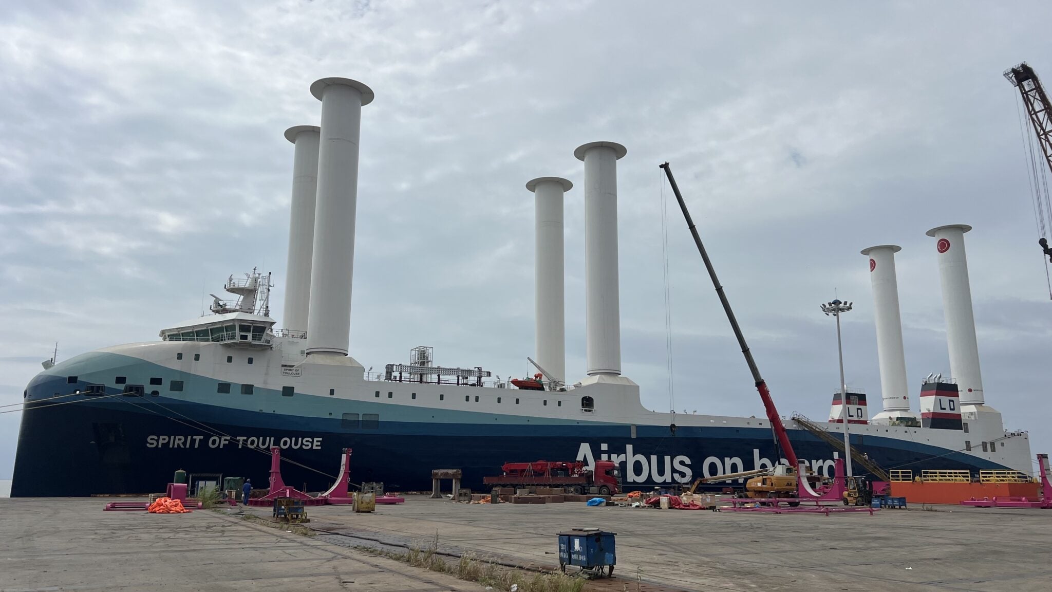 Airbus RoRo vessel Spirit of Toulouse docked in Shanghai with six towering white Norsepower rotor sails installed along its deck.