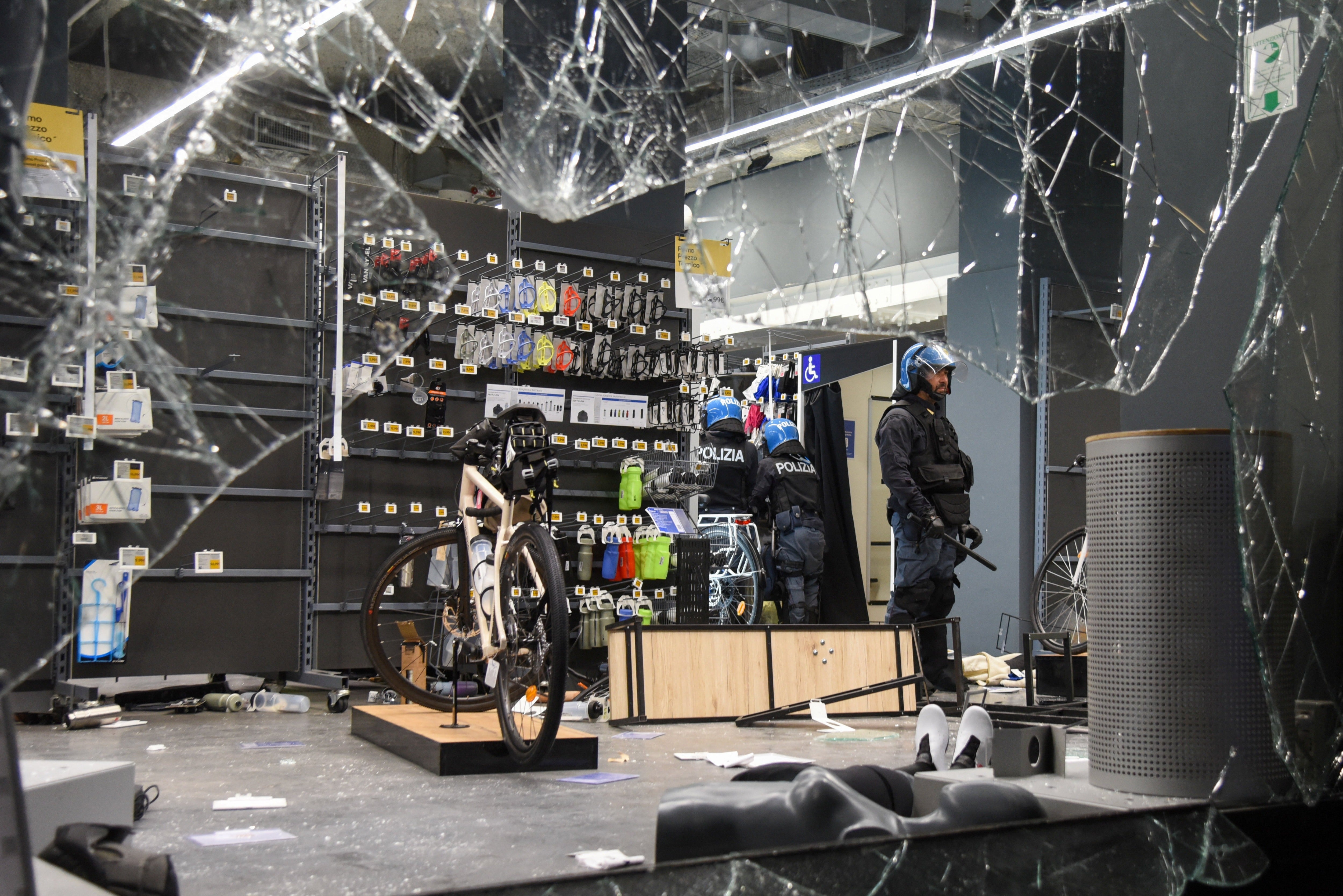 Police stand inside a Decathlon sporting goods store that was targeted during protests over the rising cost of living in Milan, Italy, October 18, 2026