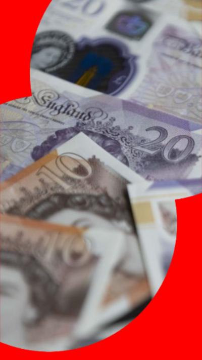 Several £10 and £20 notes lying on top of each other. 