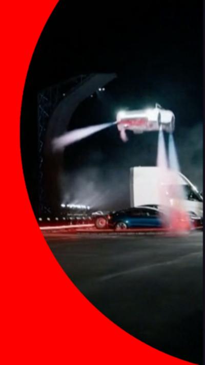 A white Tesla Roadster car appearing to fly