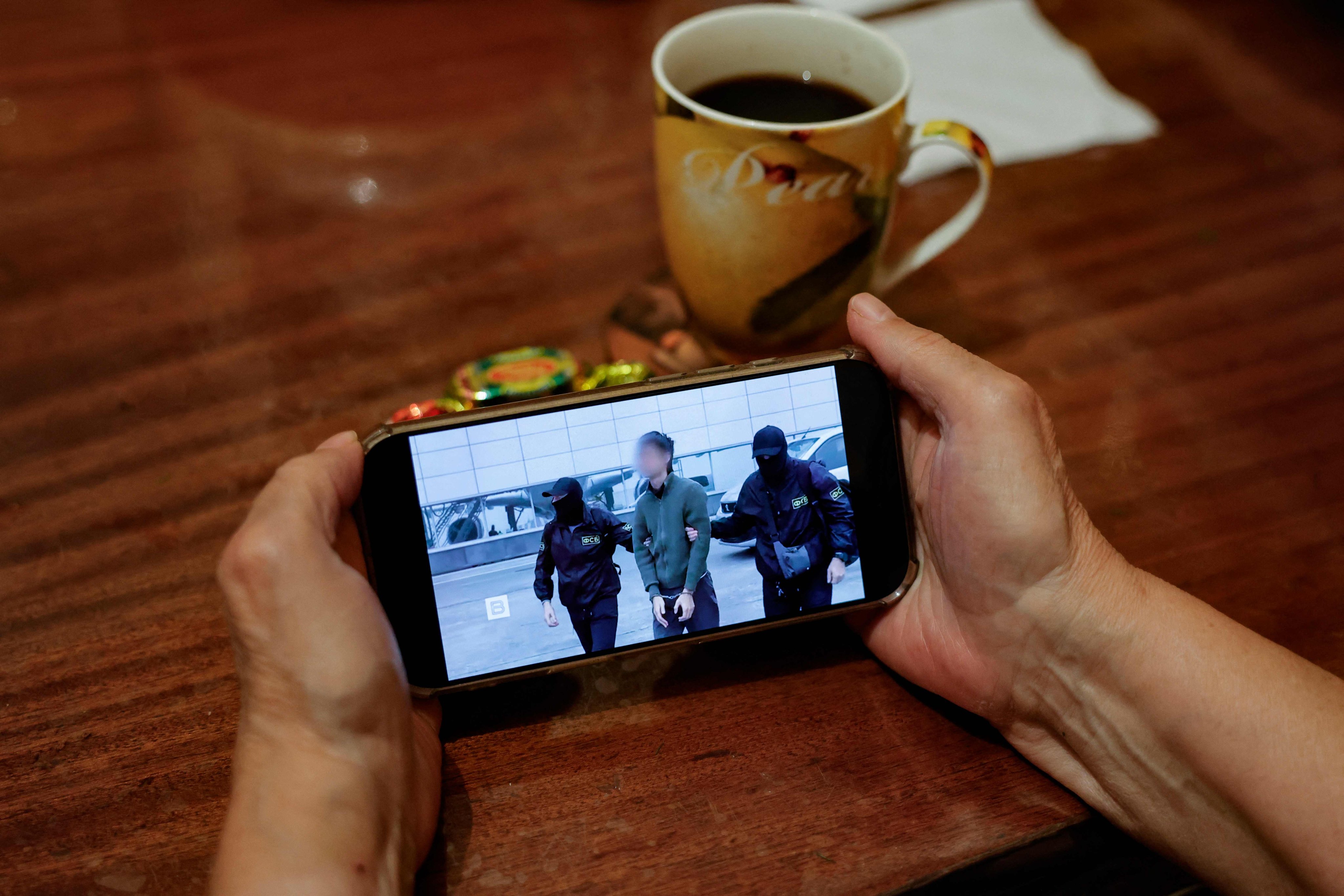 Russian security service footage of the arrest of a Japanese journalist accused of espionage, on a smartphone in Moscow. Photo: AFP